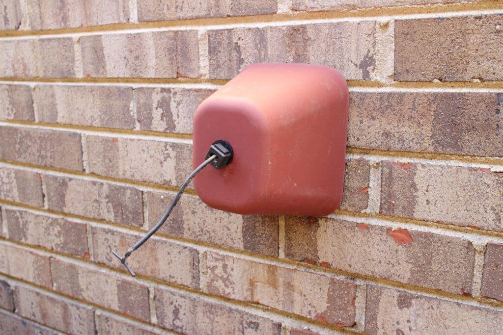 Outside Faucet Cover Protection from Freezing on Brick Wall during Winter