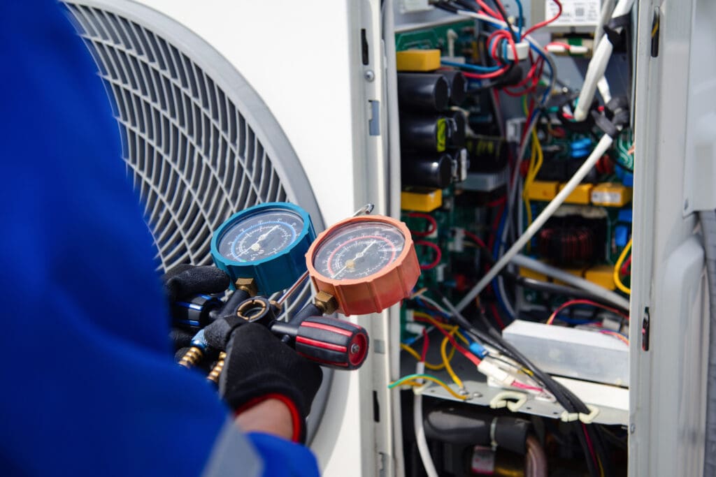HVAC technician measuring refrigerant in a heat pump